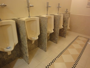 new york athletic club. Talisen Construction Management & General Contracting: White urinals separated by marble partitions
