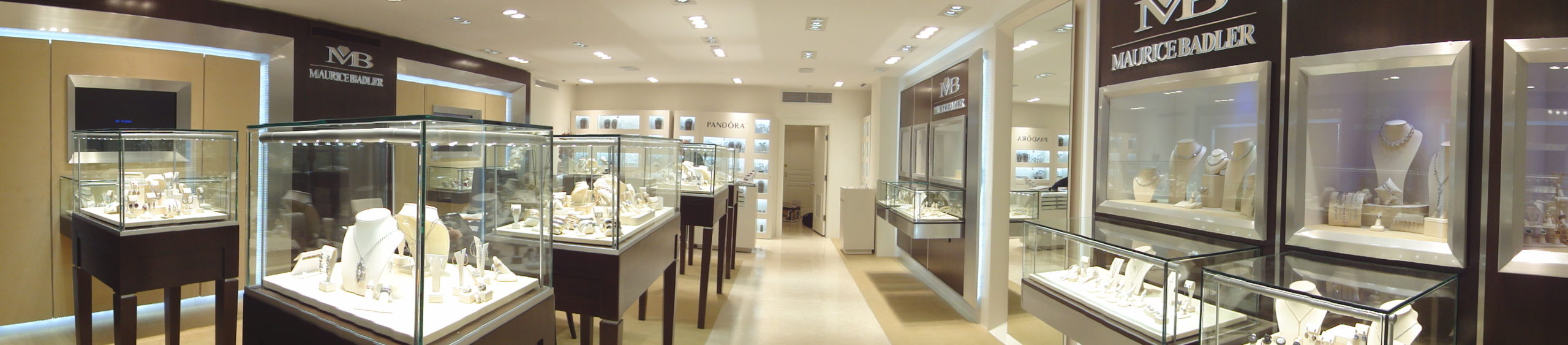 Wide-angle displaying three glass jewelry cases and two counters