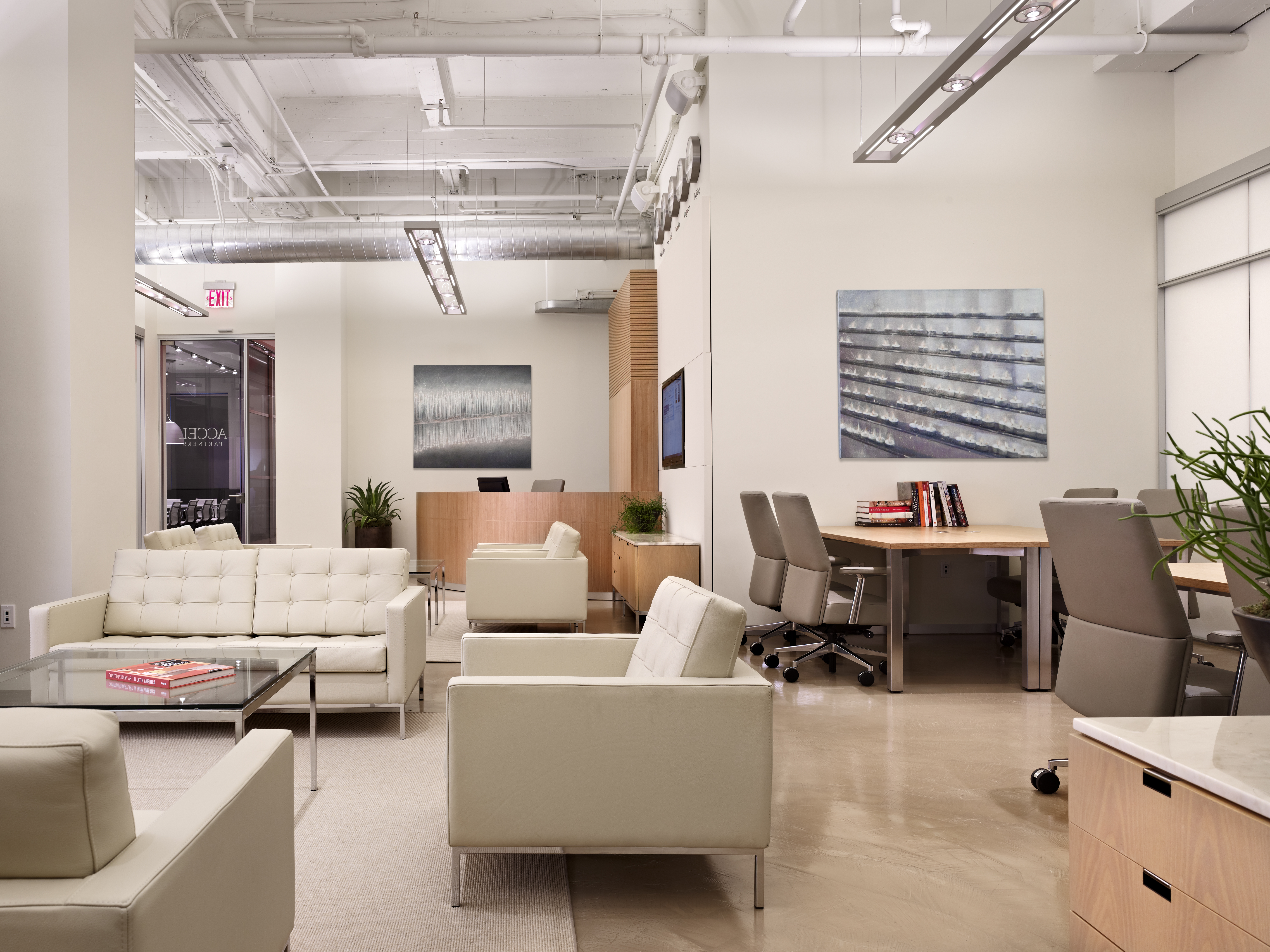 Talisen Construction Corporation: Construction Management and General Contractor. Accel Partners, 111 Eighth Avenue, New York. Community work area with couch and table area on the left and worktables and chairs on the right.