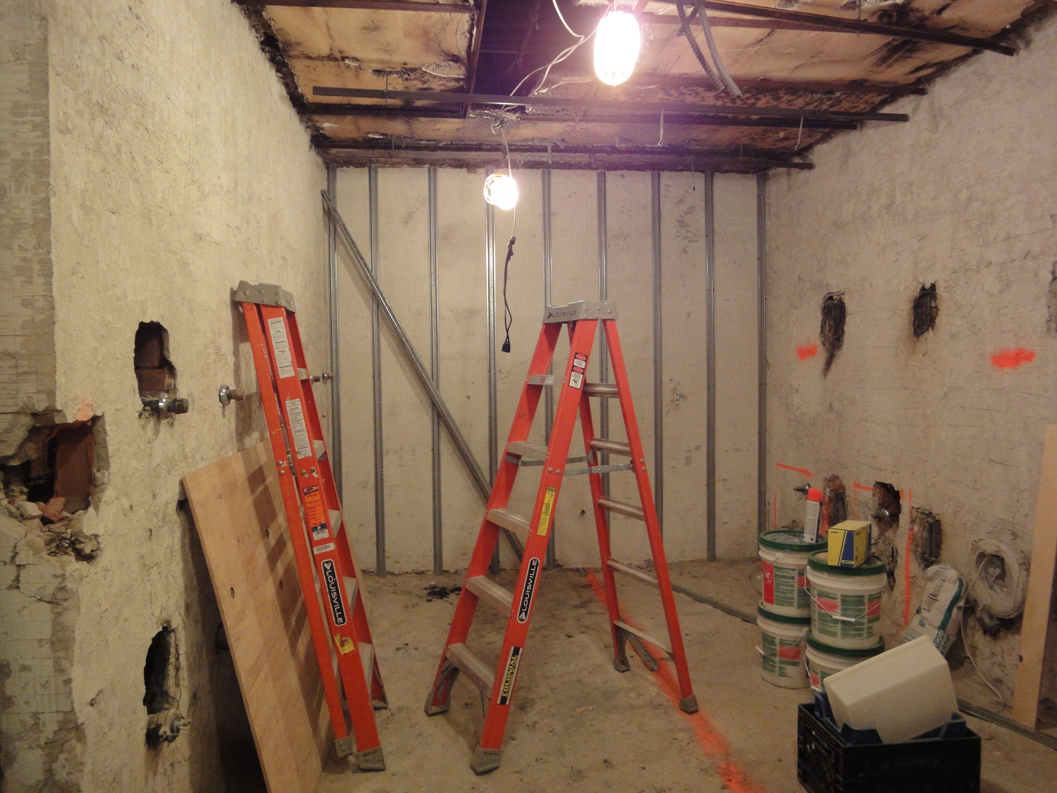 new york athletic club. Talisen Construction Management & General Contracting: Construction site of bathroom. Ladders and metal wall studs occupy the room with a temporary light.