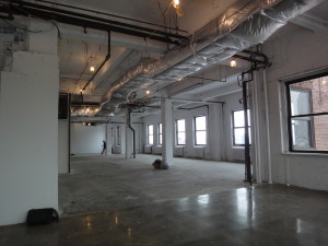 Talisen Construction Corporation: Construction Management and General Contracting. Google, 111 Eighth Avenue, New York: Empty construction space showing the space with wide windows, columns, and wide open flooring.