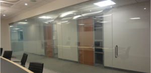 Glass partition wall of conference room with electrostatic technology not activated, leaving a standard glass look.