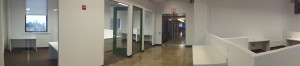 Talisen Construction Corporation: Construction Management and General Contracting. Google, 111 Eighth Avenue, New York: Wide-angle showing the spaces stone flooring supplemented by carpeted offices with green doors.