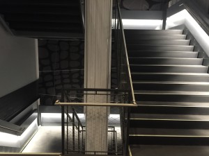 Talisen Construction Corporation: Construction Management and General Contractor. Google, 111 Eighth Ave. Gray concrete staircase with metal railing, base lighting, and steel cage safety enclosures.