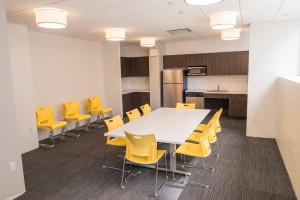 Talisen Construction Corporation: Construction Management and General Contractor. Manhattan Children's Center, 100 West 93rd Street. Teacher lounge table with yellow plastic chairs and rounded light fixtures.