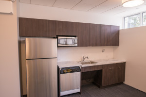 Talisen Construction Corporation: Construction Management and General Contractor. Manhattan Children's Center, 100 West 93rd Street. Kitchen area in teacher's lounge with stainless steel appliances and dark wood cabinetry.