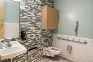 Talisen Construction Corporation: Construction Management and General Contractor. Manhattan Children's Center, 100 West 93rd Street. Bathroom with gray/blue tile scheme, new wooden cabinetry, and bathroom accessories.