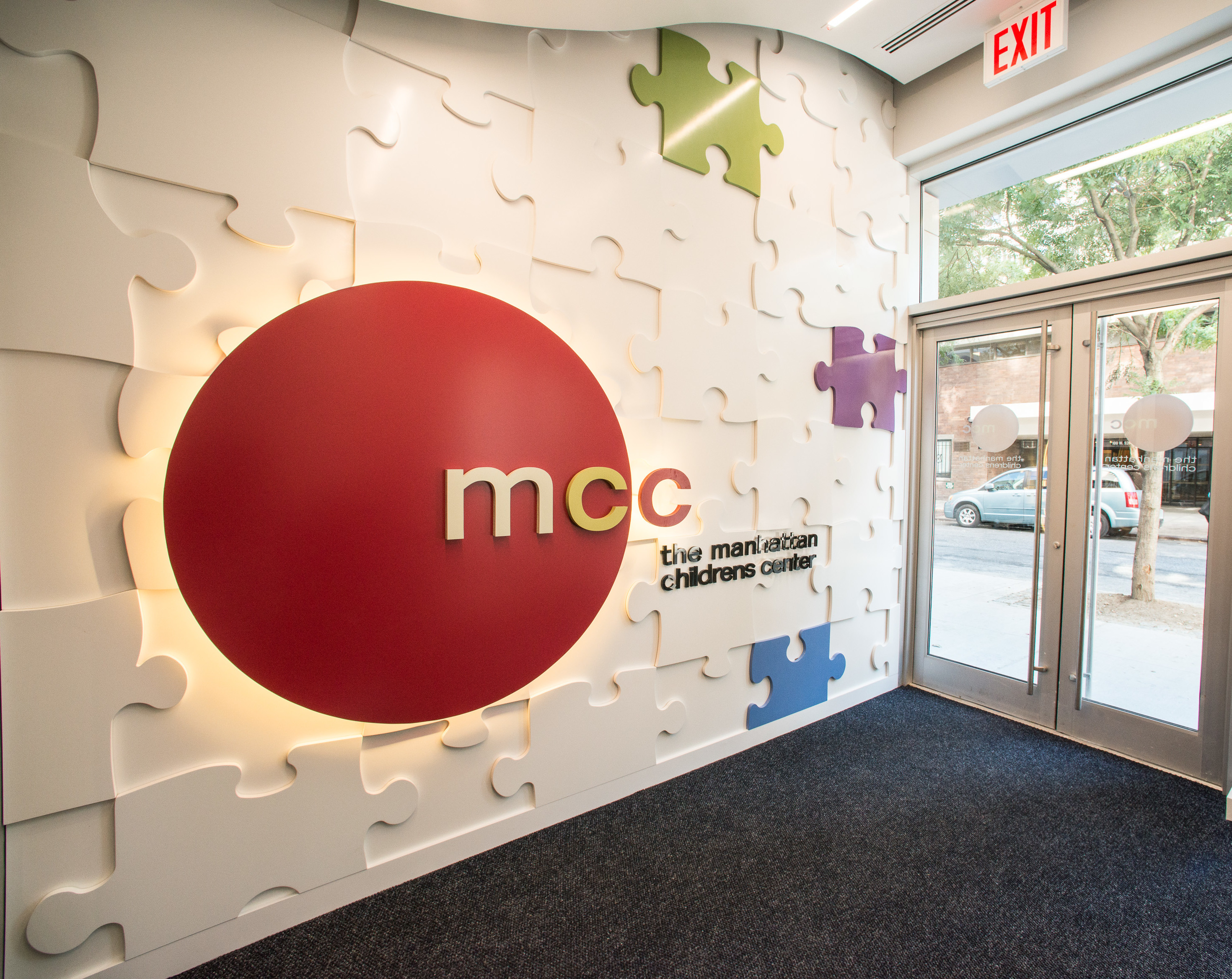 Talisen Construction Corporation: Construction Management and General Contractor. MCC logo in puzzle-piece themed wall design.