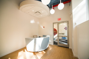 Talisen Construction Corporation: Construction Management and General Contractor. Manhattan Children's Center, 100 West 93rd Street. Reception area with blue semi-circle desk, floating ceiling and globe-like lighting fixtures.