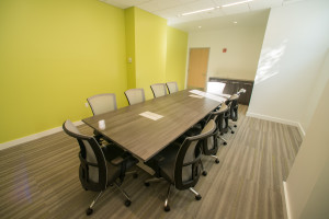 Talisen Construction Corporation: Construction Management and General Contractor. Manhattan Children's Center, 100 West 93rd Street. Large sunlit conference room with dark wooden table and lime green wall; gray carpet on floor.