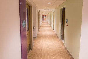 Talisen Construction Corporation: Construction Management and General Contractor. Manhattan Children's Center, 100 West 93rd Street. Hallway with relaxed lighting and pastel colors. Wood flooring leads the way.