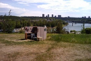 office cubicle set up outside near river with city in background