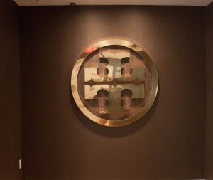 Talisen Construction: Construction Management and General Contractor. Tory Burch, 11 West 19th Street, New York. elevator lobby with brown walls and gold tory burch logo