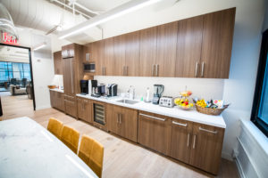 Kitchen with table, wood cabinets, and snacks