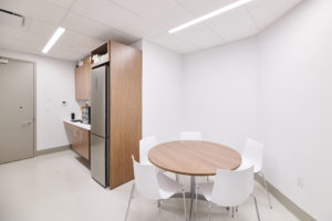 break room with table, chairs, and pantry
